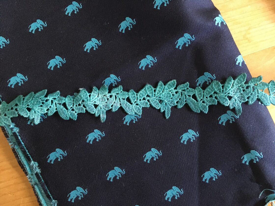 Lace has been hand painted to match this silk fabric with an elephant design
